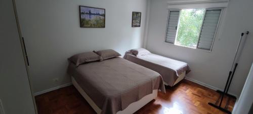 a bedroom with two beds and a window at Big apartment close to Allianz Park in Sao Paulo