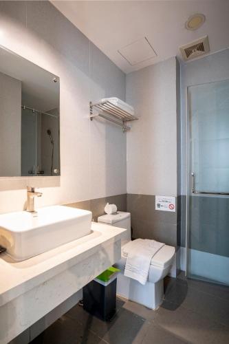 a bathroom with a sink and a toilet at Sonder - Tan Son Nhat Airport Hotel in Ho Chi Minh City