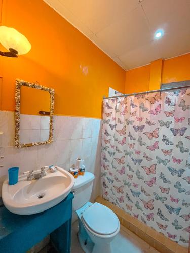 a bathroom with a sink and a toilet and a shower at Surfari Bocas in Bocas del Toro