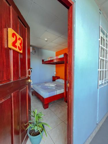 a room with a bunk bed and a door at Surfari Bocas in Bocas del Toro