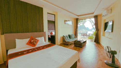 a bedroom with a large bed and a living room at Le Pont Bungalow Cat Ba in Cat Ba