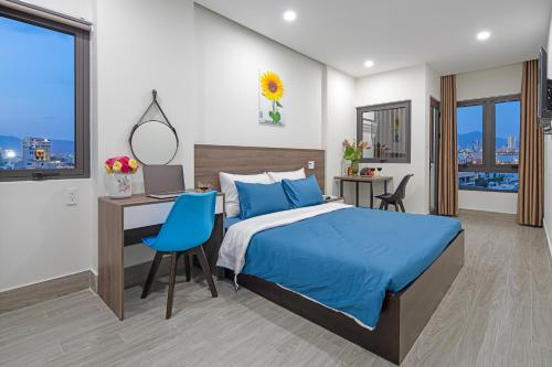 een slaapkamer met een bed en een bureau met een computer bij TIDITEL Hotel and Apartment in Da Nang