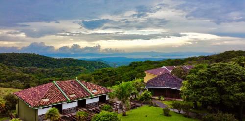 an aerial view of a house with mountains in the background at Hotel Montaña Monteverde in Monteverde Costa Rica