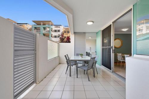 a balcony with a table and chairs on it at Unit 30-31 12 Perry Street in Coolum Beach