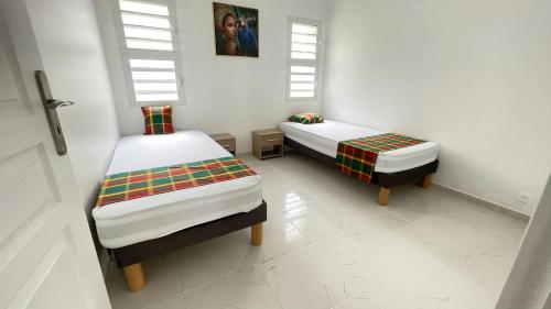 Postel nebo postele na pokoji v ubytování LE MANGO 'Lodge