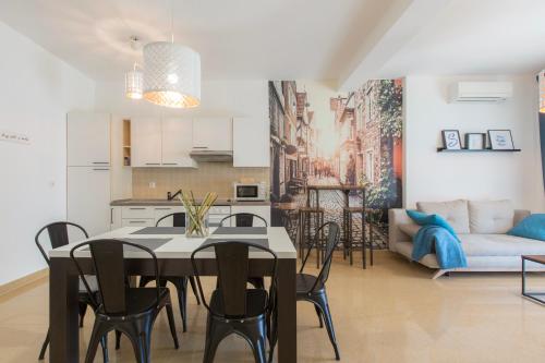 a kitchen and living room with a table and chairs at Istria Sea Side Apartments in Labin