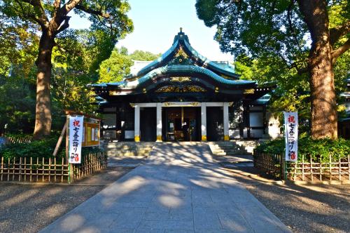 a temple in a park with trees in front of it at Tabist A Mirai Oji in Tokyo