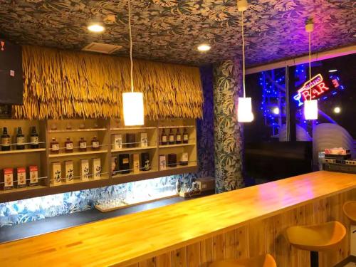 a bar with a wooden counter in a restaurant at 【CLUB DEEP BLUE】西伊豆　知る人ぞ知る美しい入江が眺める貸別荘！最大44人宿泊可能！ in Numazu