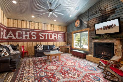 a living room with a tv and a fireplace at Bunkhouse in West Yellowstone