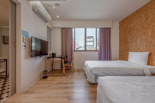 Postel nebo postele na pokoji v ubytování Light Hostel - Tainan