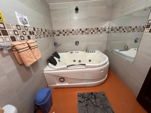 a white bathroom with a tub and a sink at Hostal la perla del sur in Quito