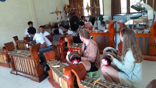 a group of people sitting in chairs holding stuffed animals at Edu Hotel (Hotel Edukasi SMK PK) in Bangli