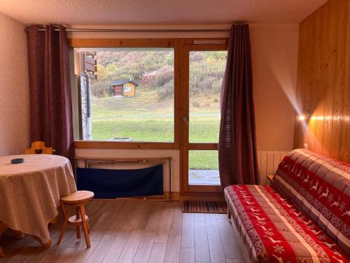 a room with a table and a window with a view of a barn at Appartement Méribel, 2 pièces, 4 personnes - FR-1-355-246 in Les Allues