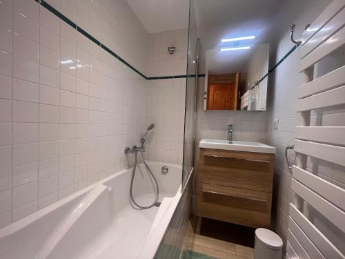 a bathroom with a tub and a sink and a shower at Appartement Méribel, 2 pièces, 4 personnes - FR-1-355-246 in Les Allues