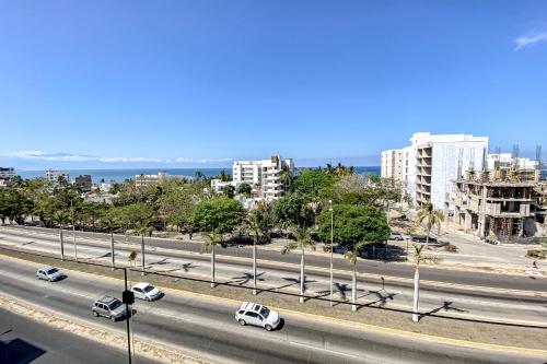 a highway with cars driving down a road with buildings at Vista Bucerias 401 in Bucerías