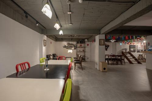 a room with chairs and a table in a room at Light Hostel in Chiayi City