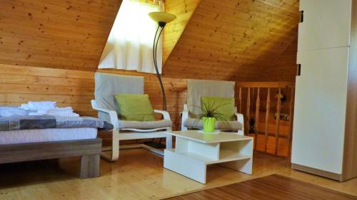 sala de estar con 2 sillas y mesa en Lodge Bled, en Bled