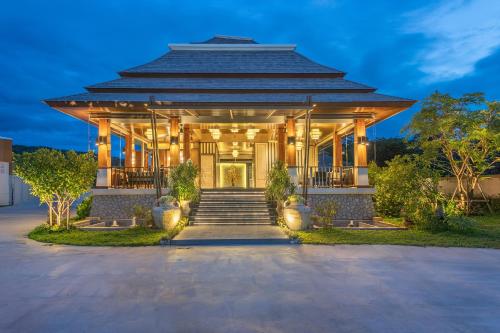 a building with a staircase leading up to it at Treepana Boutique Hotel, Huahin in Hua Hin