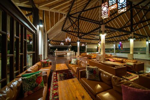a lobby with couches and tables in a building at Turi Beach Resort in Nongsa