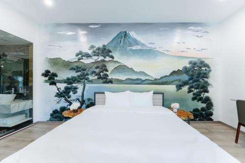 a bedroom with a mountain mural on the wall at Su Casa Hanoi Old Quarter in Hanoi