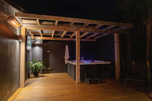 a room with a desk in the middle of a room at The Black Barn in Auckland