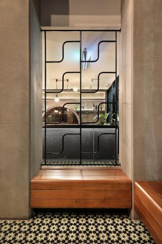 a room with a window with a wooden bench at The Canvas Apartment Hotel in Melbourne