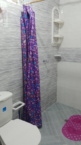 a shower with a purple shower curtain in a bathroom at Casa Shalom R.G. in Paipa