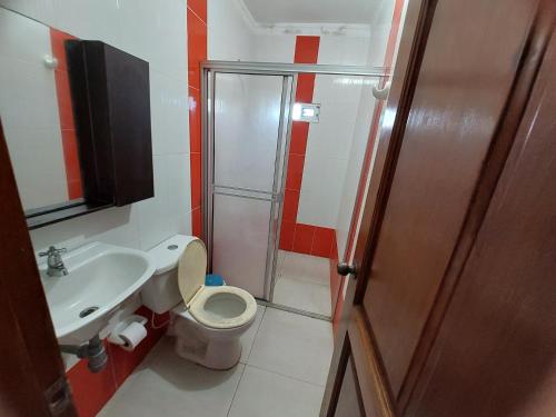 a small bathroom with a toilet and a sink at Alojamiento villa maría in Coveñas