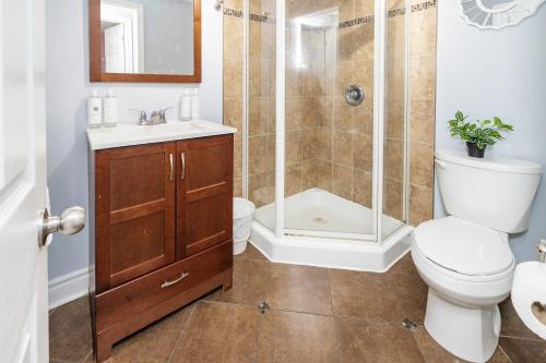 a bathroom with a shower and a toilet and a sink at 2BR Apartment with Private Rooftop Terrace in Ottawa