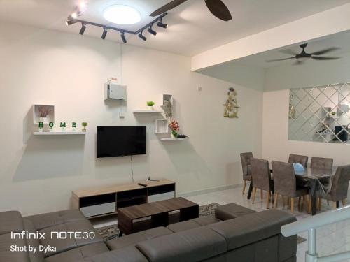 a living room with a couch and a tv at DAN'S Homestay Business Suite Home in Kota Tinggi
