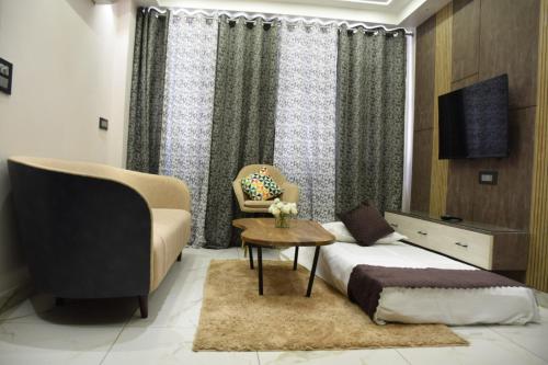 a bedroom with a bed and a chair and a table at 2BHK luxury Escape in rishikesh in Rishīkesh