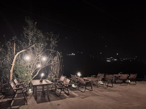 a group of tables and chairs at night at Pavi garden in Sa Pa