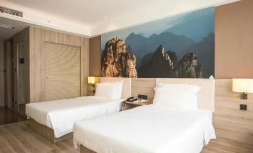 A bed or beds in a room at Atour Hotel Hefei Ma'anshan Road