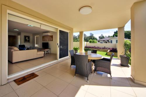 a living room with a table and chairs at Geckos at South West Rocks - 29 Marlin Drive in South West Rocks