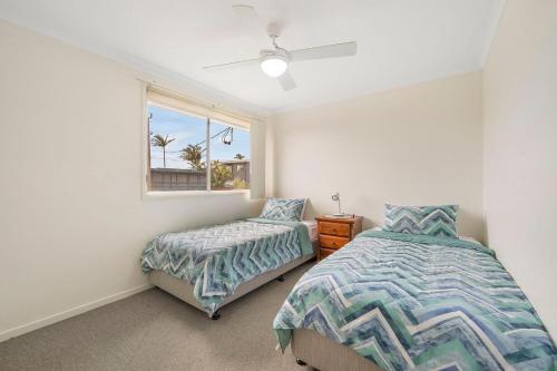 a bedroom with two beds and a window at Topviews 15 Second Av BH in Bonny Hills