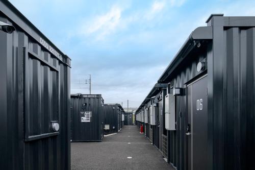 a row of black containers sitting next to each other at HOTEL R9 The Yard Tsuchiura in Tsuchiura