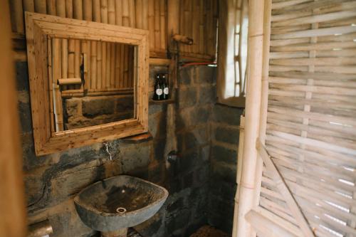 an old bathroom with a sink and a window at Sun Sang Eco Retreats in Tabanan