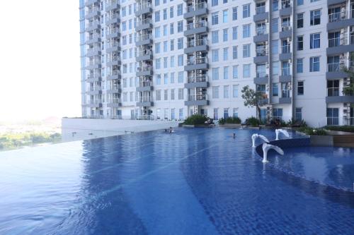 uma piscina em frente a um grande edifício em Nagoya 名古屋 at Benson Apartment em Surabaya