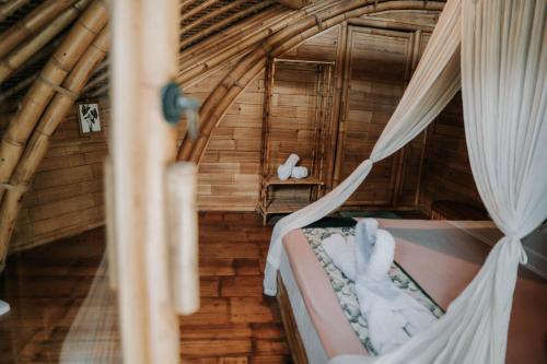 a bedroom in a tree house with a bed at Sun Sang Eco Retreats in Tabanan