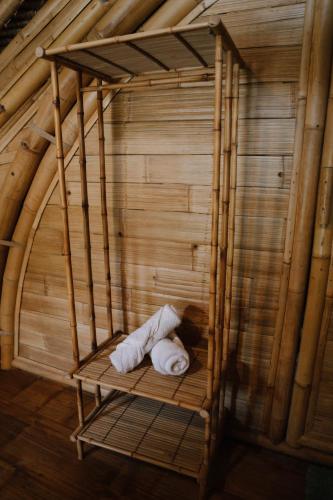 a round room with a bed in a wooden room at Sun Sang Eco Retreats in Tabanan