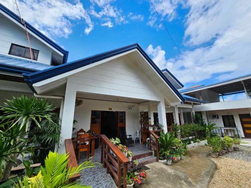 a small house with a blue roof at Bella Vita Guest House in Coron