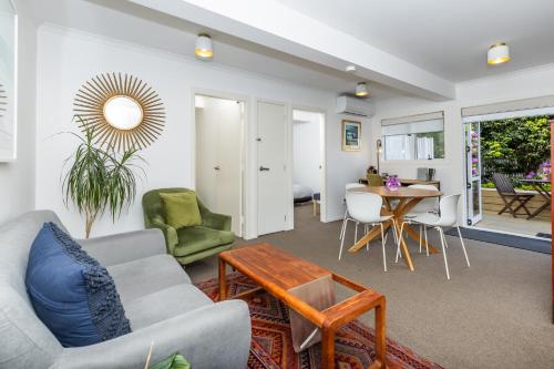 a living room with a couch and a table at 2 Bedroom Home away from Home near CBD & private parking in Hamilton