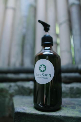 a bottle of sun saving soap sitting on a table at Sun Sang Eco Retreats in Tabanan