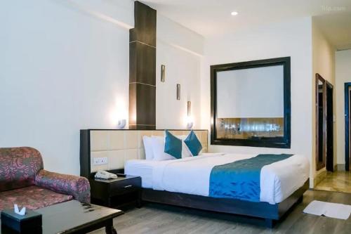 um quarto de hotel com uma cama e uma cadeira em Staynest gangtok 300 mtr from MALL ROAD em Gangtok