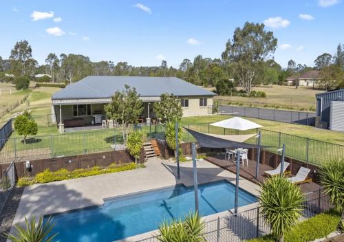 an aerial view of a house with a swimming pool at Ponderosa Homestead in Branxton