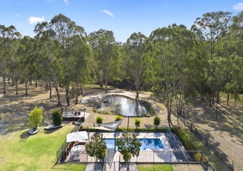 an aerial view of a pool in a park with trees at Ponderosa Homestead in Branxton