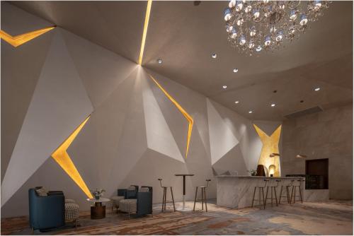 a room with a large wall with a ceiling with a chandelier at Holiday Inn Beijing Focus Square by IHG in Beijing