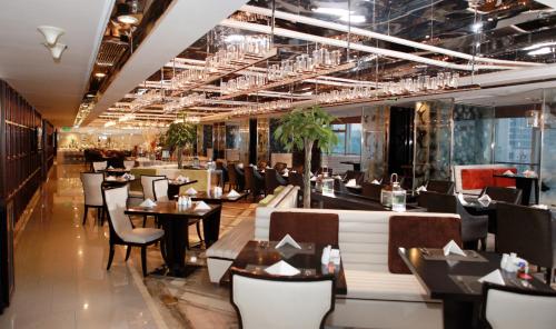 a restaurant with tables and chairs in a room at Holiday Inn Beijing Focus Square by IHG in Beijing