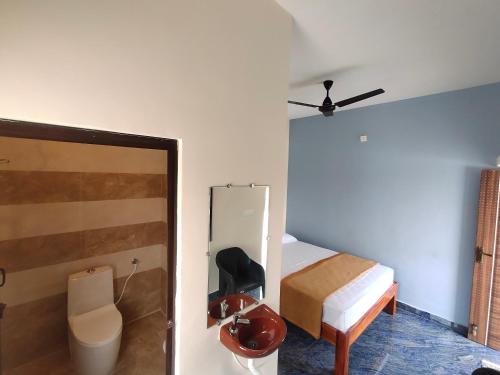 a bedroom with a bed and a ceiling fan at RPM home stay in Tiruvannāmalai