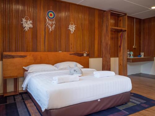 a bedroom with a large bed with a stuffed animal on it at Timba Garden FREE TOWN AND JETTY TRANSPORT in Semporna